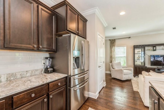 kitchen featuring dark wood-type flooring, dark brown cabinetry, tasteful backsplash, and ornamental molding