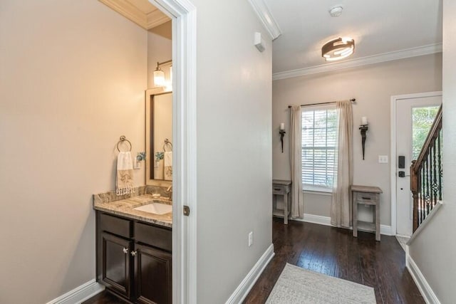 bathroom with ornamental molding, vanity, and wood-type flooring