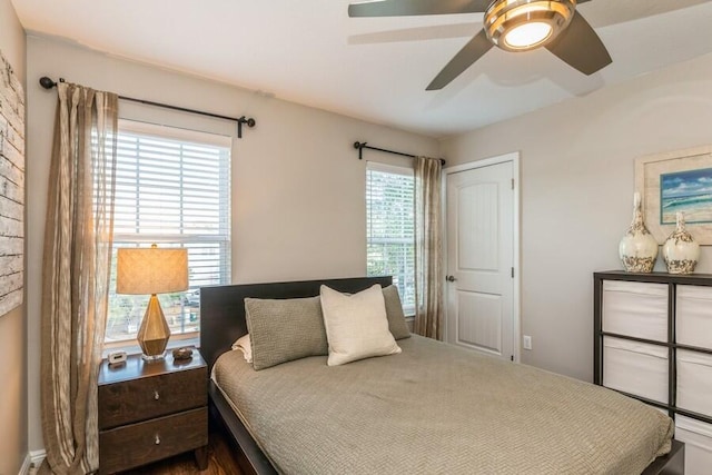 bedroom featuring multiple windows and ceiling fan