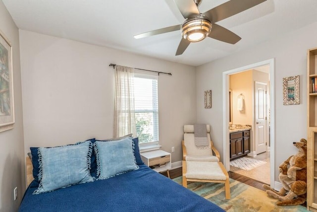 bedroom with ensuite bath, ceiling fan, and hardwood / wood-style floors