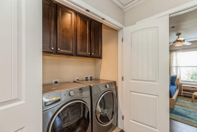 laundry area featuring hardwood / wood-style flooring, ceiling fan, crown molding, cabinets, and independent washer and dryer