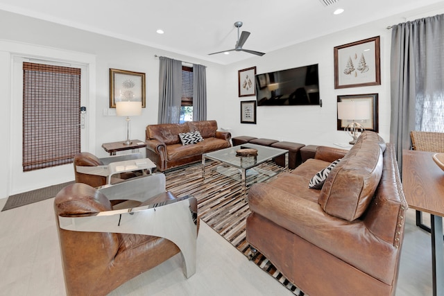 living room featuring ceiling fan and light hardwood / wood-style flooring