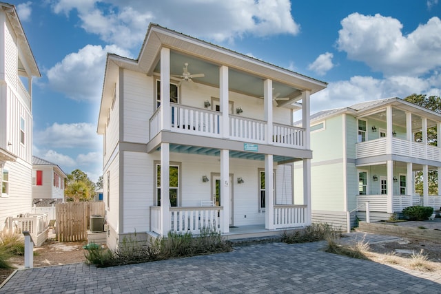 view of front facade featuring cooling unit, a porch, ceiling fan, and a balcony