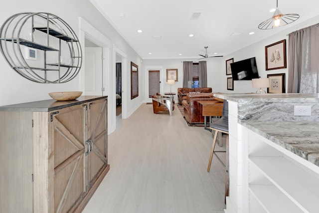 living room featuring ceiling fan and light hardwood / wood-style flooring