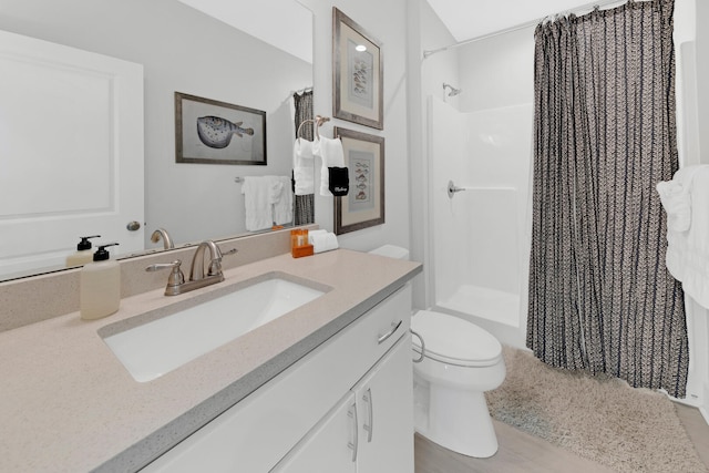 bathroom with vanity, toilet, and a shower with shower curtain