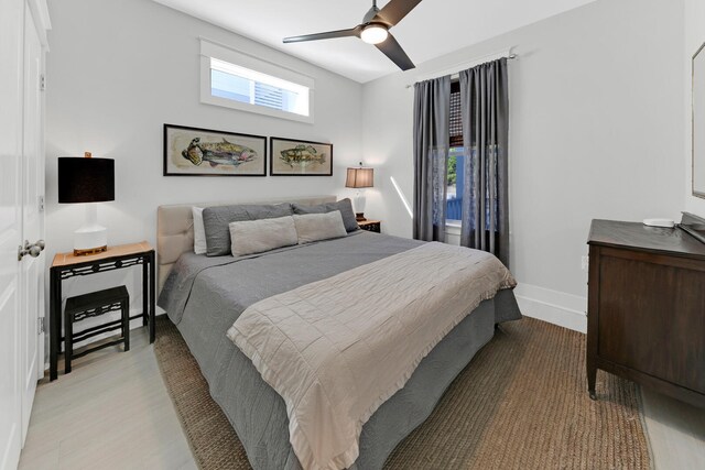 bedroom with ceiling fan and light wood-type flooring