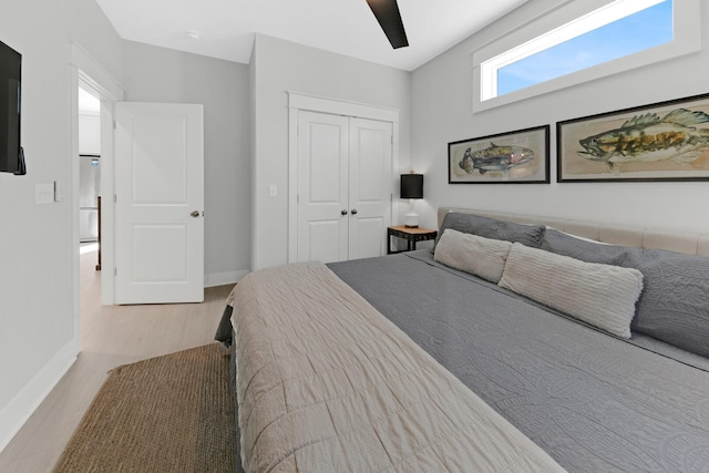 bedroom with a closet, ceiling fan, and light wood-type flooring