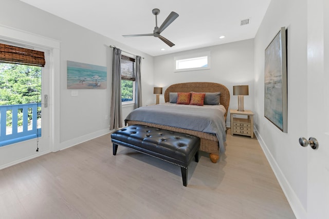 bedroom featuring multiple windows, ceiling fan, and light wood-type flooring