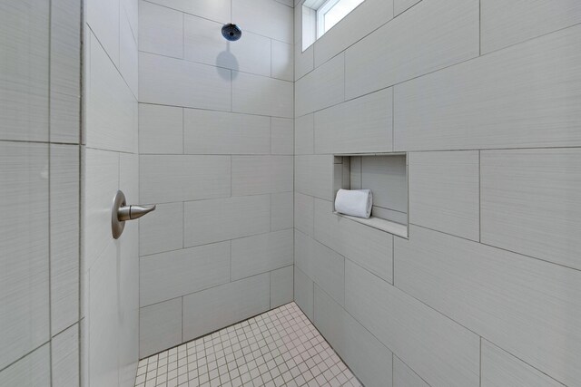 bathroom with tiled shower