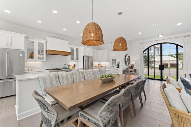 dining area with ornamental molding and sink