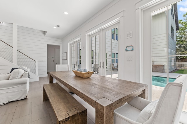 dining room featuring french doors and light tile patterned flooring