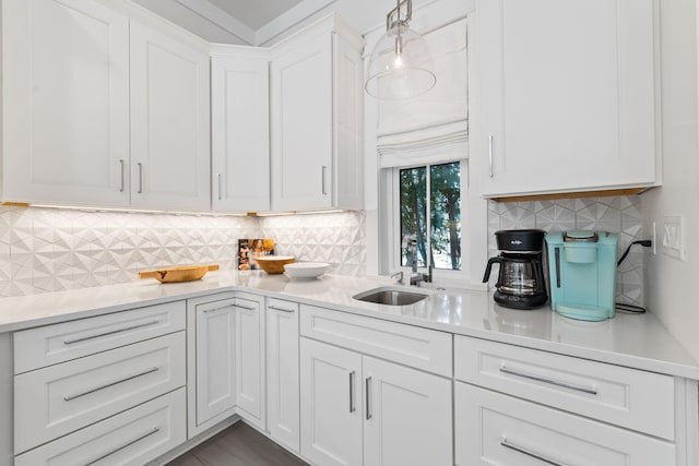 kitchen with decorative backsplash, sink, and white cabinets