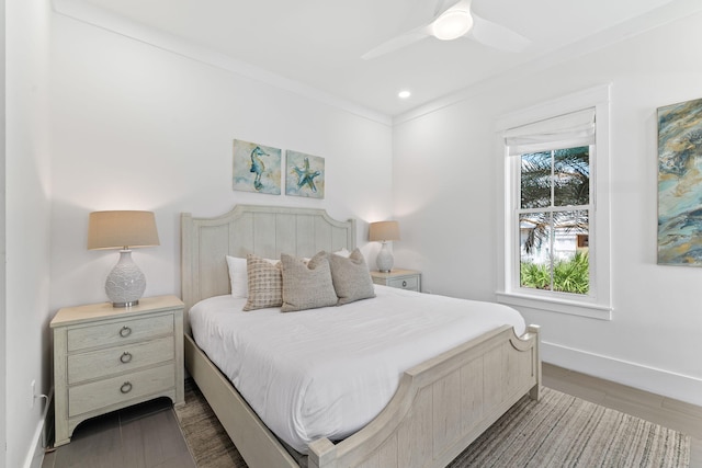 bedroom with ornamental molding, ceiling fan, and dark wood-type flooring