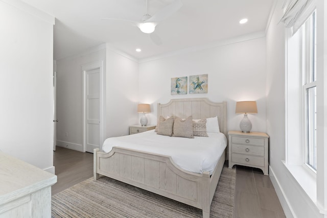 bedroom with crown molding, ceiling fan, multiple windows, and light wood-type flooring