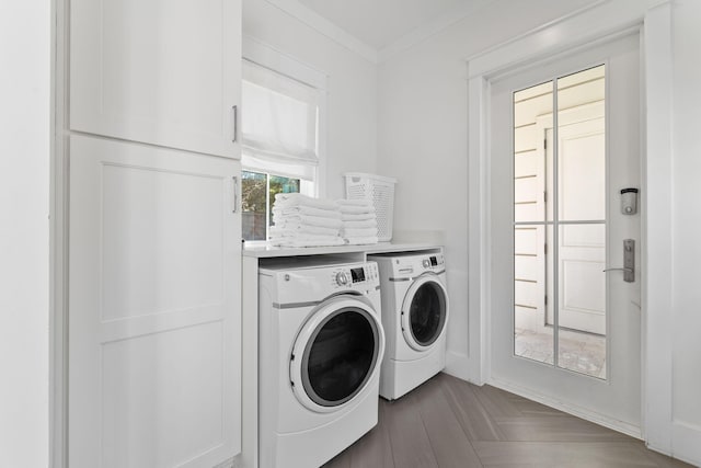 laundry area with dark parquet flooring, ornamental molding, and washer and dryer