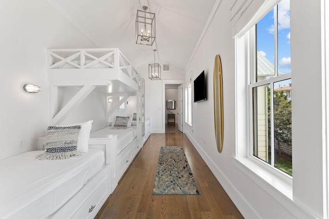 hall with lofted ceiling, an inviting chandelier, and dark hardwood / wood-style flooring