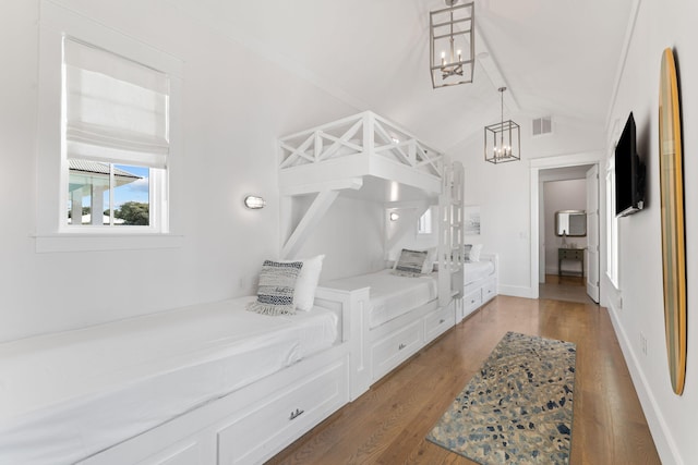 interior space with lofted ceiling, a notable chandelier, and hardwood / wood-style floors