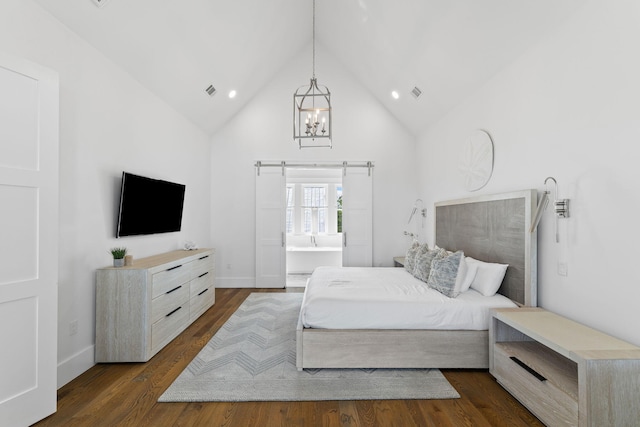 bedroom with a barn door, high vaulted ceiling, and dark hardwood / wood-style flooring