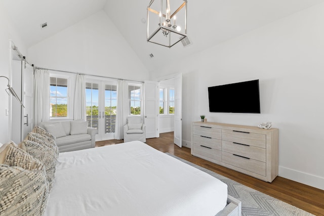 bedroom with dark wood-type flooring, french doors, high vaulted ceiling, and an inviting chandelier