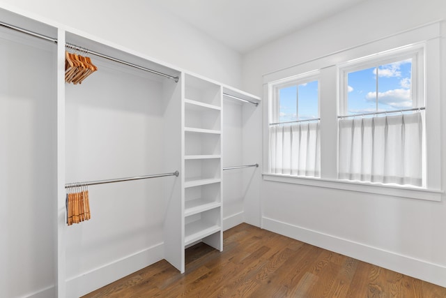 walk in closet with hardwood / wood-style floors