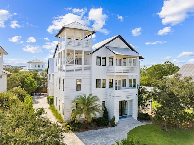 view of front of property with a front lawn and a balcony