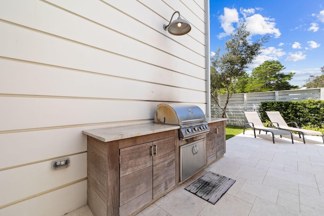 view of patio featuring a grill and an outdoor kitchen