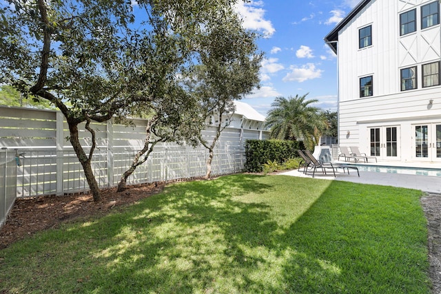 view of yard with a patio area and french doors