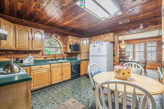 kitchen with black dishwasher, white refrigerator, wood ceiling, and wooden walls