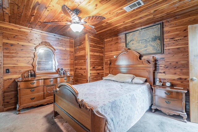 bedroom featuring carpet, ceiling fan, wooden walls, and wood ceiling