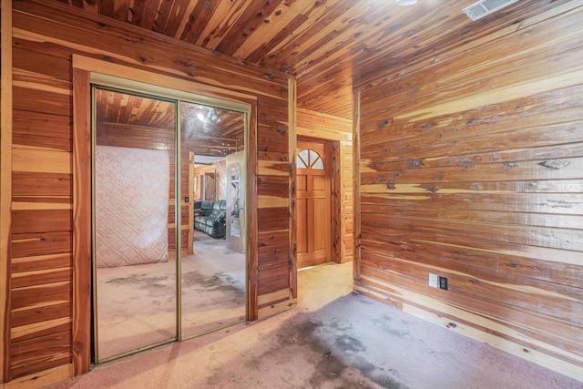 interior space with wooden ceiling and wooden walls