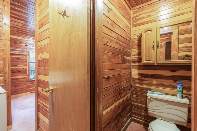 bathroom featuring wood walls, toilet, and wooden ceiling