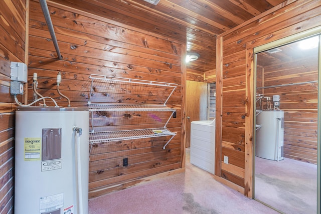 spacious closet featuring electric water heater, washer / clothes dryer, and carpet