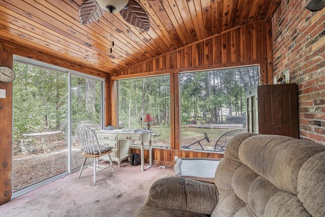 sunroom / solarium featuring ceiling fan, vaulted ceiling, and wood ceiling