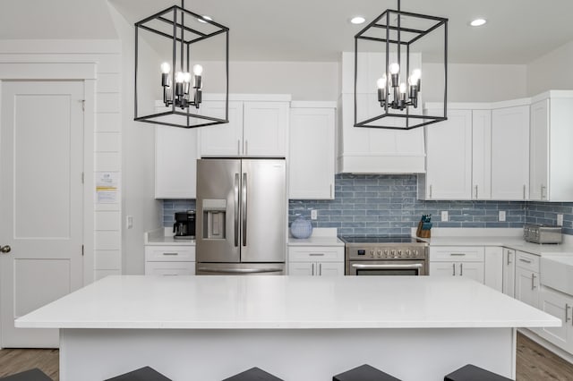 kitchen featuring light countertops, appliances with stainless steel finishes, and white cabinetry