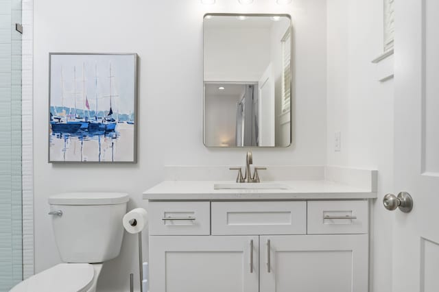 bathroom featuring vanity, toilet, and an enclosed shower