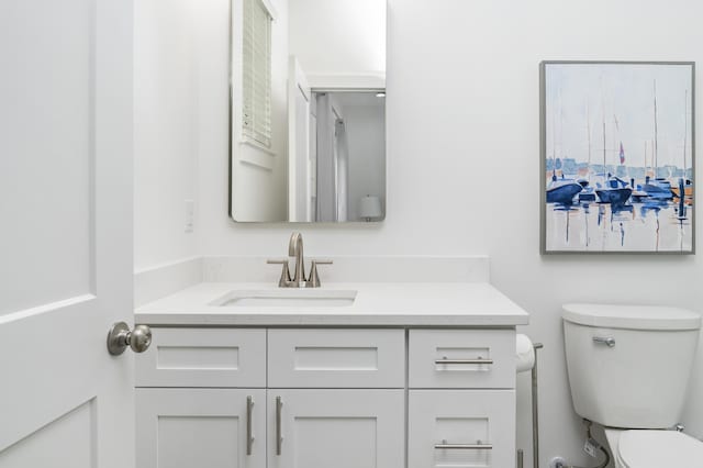 bathroom featuring toilet and vanity