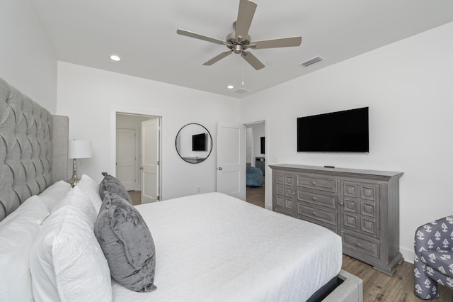 bedroom featuring ceiling fan, recessed lighting, visible vents, baseboards, and light wood-style floors