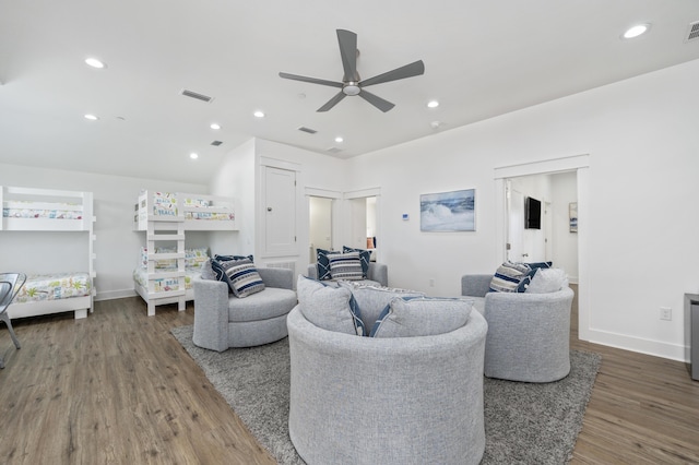 living room with baseboards, visible vents, dark wood-style flooring, and recessed lighting