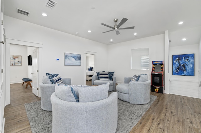 living room with ceiling fan, recessed lighting, visible vents, and light wood-style floors