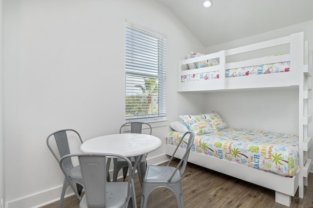 bedroom with dark wood-type flooring, lofted ceiling, baseboards, and recessed lighting