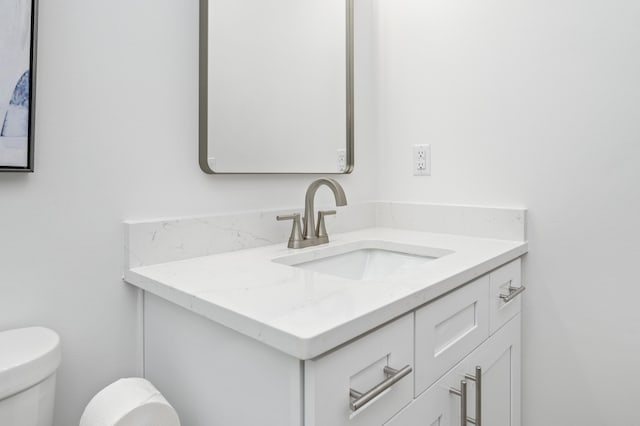 bathroom with toilet and vanity