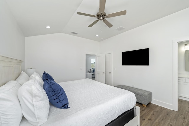 bedroom with visible vents, lofted ceiling, ensuite bath, ceiling fan, and wood finished floors