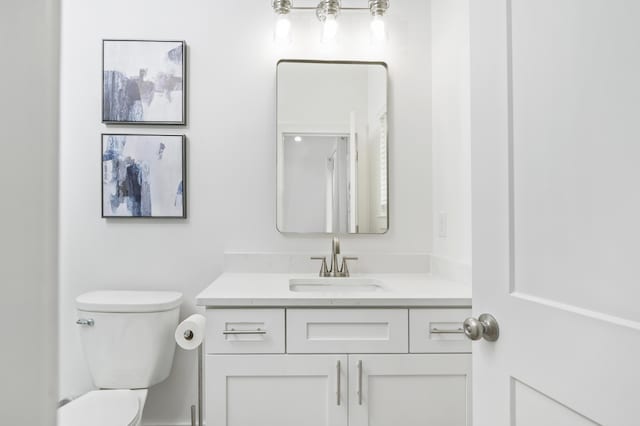 bathroom featuring vanity and toilet