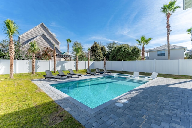 view of swimming pool featuring a pool with connected hot tub, a fenced backyard, a patio, and a lawn