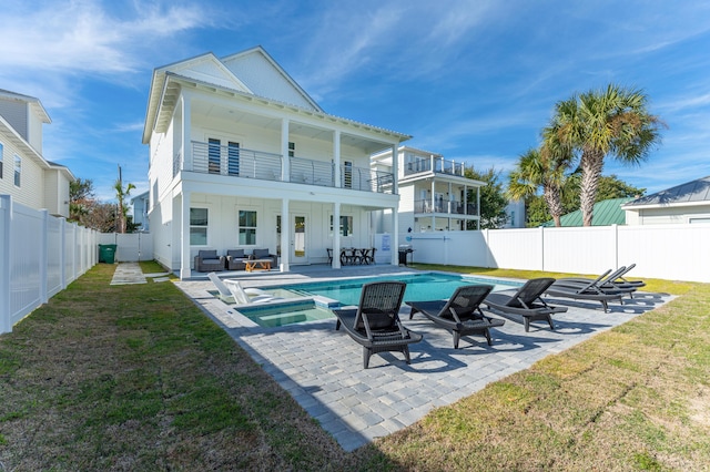 rear view of property with a patio area, a fenced backyard, outdoor lounge area, and a balcony