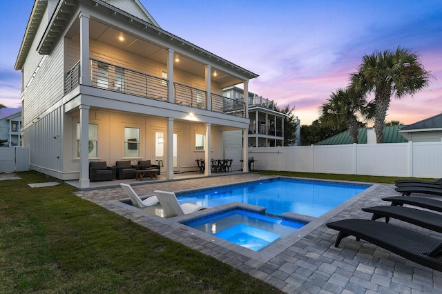 exterior space with an in ground hot tub, a fenced backyard, an outdoor living space, and a fenced in pool