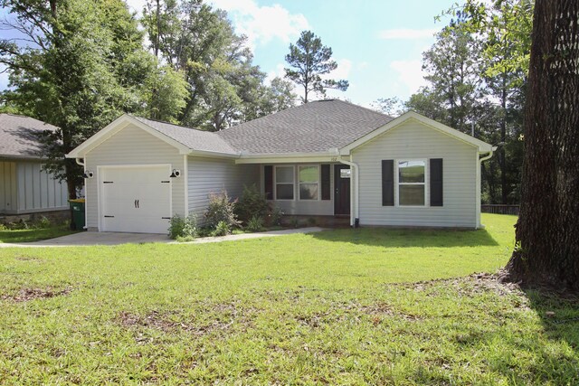 ranch-style home featuring a garage and a front yard