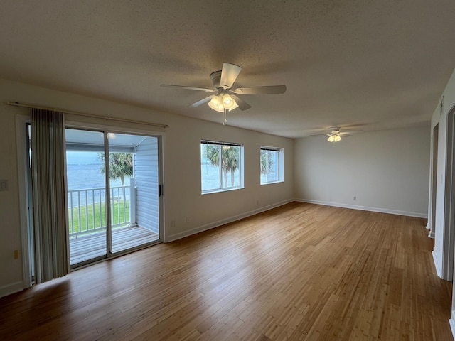 unfurnished room featuring wood finished floors, a ceiling fan, and baseboards