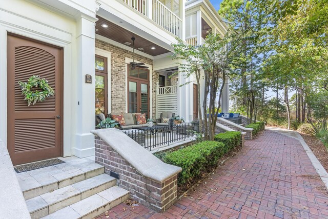 view of patio with an outdoor living space and a balcony