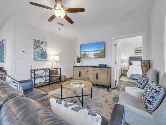 living room with hardwood / wood-style flooring and ceiling fan